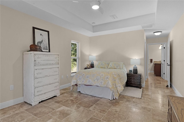 bedroom featuring stone finish floor, visible vents, and baseboards