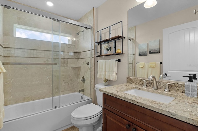 bathroom with toilet, bath / shower combo with glass door, and vanity