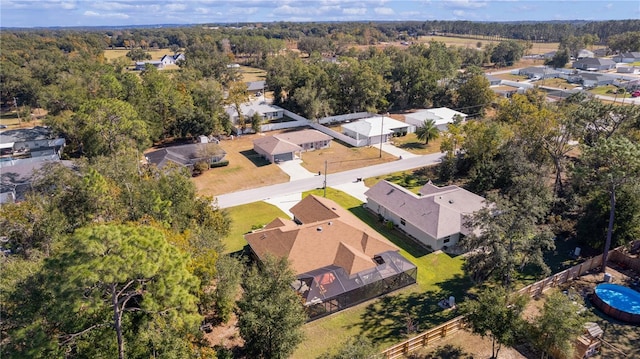 aerial view with a wooded view and a residential view