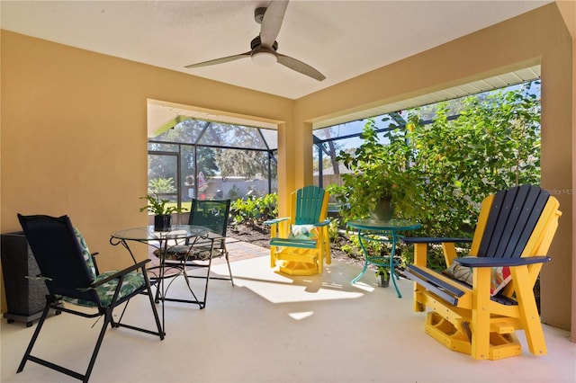 sunroom / solarium with a ceiling fan