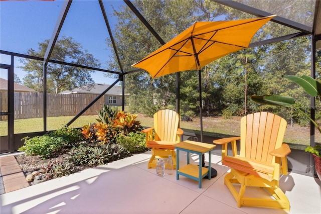 view of patio with fence and a lanai