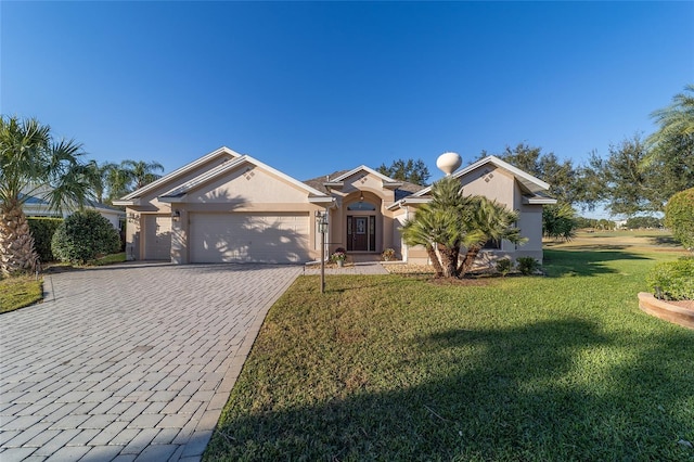 ranch-style house featuring a front lawn and a garage