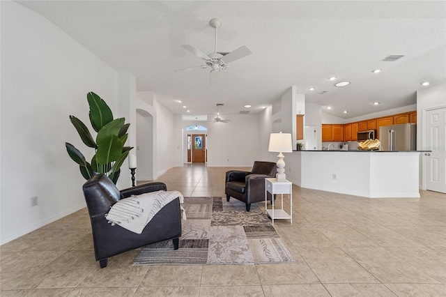 tiled living room featuring vaulted ceiling and ceiling fan