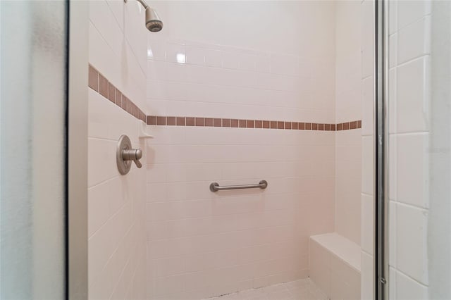 bathroom with a tile shower