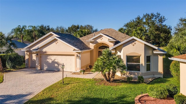 view of front of property featuring a garage and a front yard