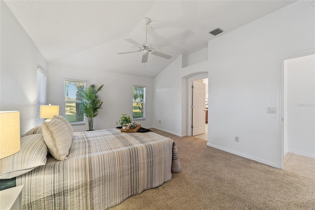 bedroom featuring ceiling fan, lofted ceiling, and light carpet