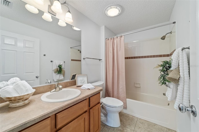 full bathroom featuring shower / bath combination with curtain, vanity, toilet, tile patterned floors, and a textured ceiling