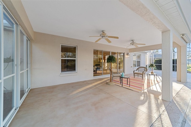 view of patio / terrace featuring ceiling fan and a lanai