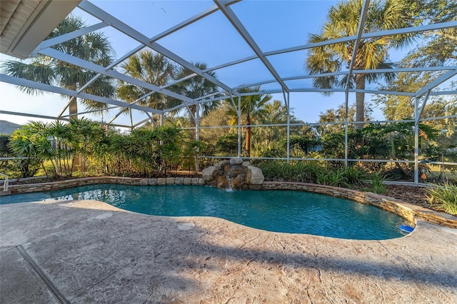 view of swimming pool featuring pool water feature, a patio area, and glass enclosure