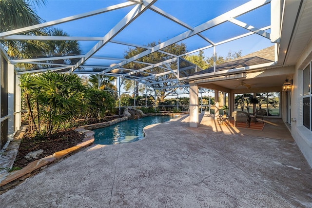 view of swimming pool featuring ceiling fan, a patio, and glass enclosure