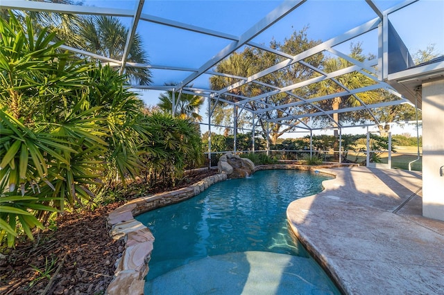 view of swimming pool featuring a lanai and a patio area