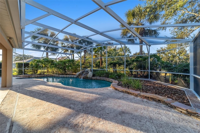 view of pool featuring a patio and glass enclosure