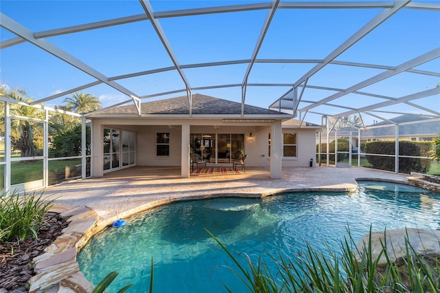 view of swimming pool featuring a lanai and a patio area