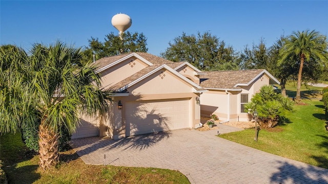 view of front facade with a garage and a front lawn