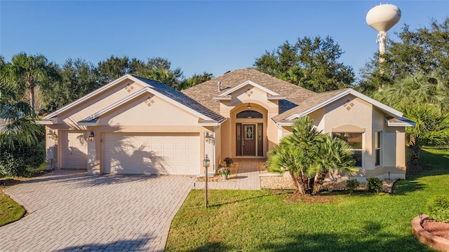 view of front facade with a garage and a front yard