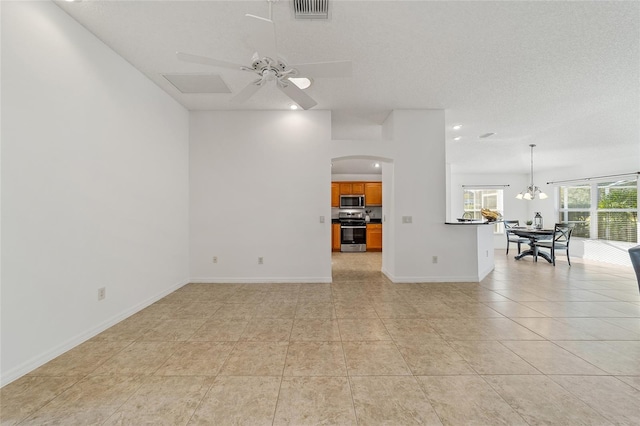 unfurnished living room with light tile patterned flooring, ceiling fan with notable chandelier, and a textured ceiling