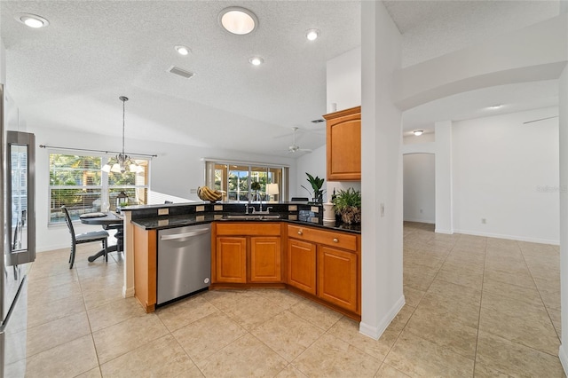 kitchen featuring lofted ceiling, sink, dishwasher, a wealth of natural light, and decorative light fixtures