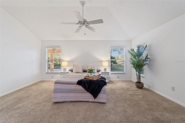 carpeted bedroom with ceiling fan, lofted ceiling, and a textured ceiling