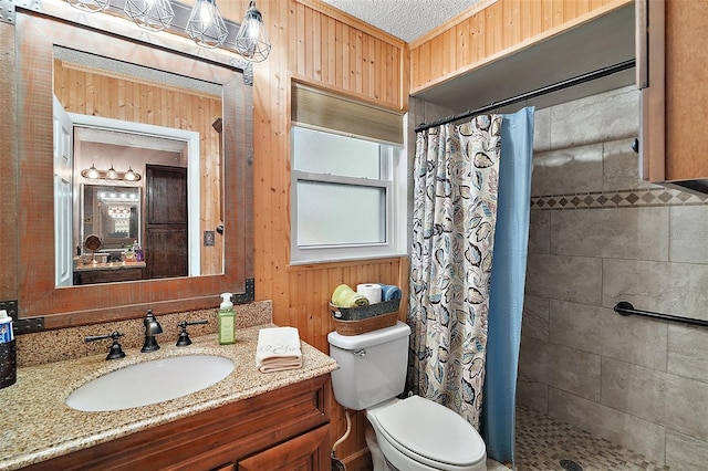 bathroom with wood walls, a textured ceiling, toilet, vanity, and a shower with shower curtain