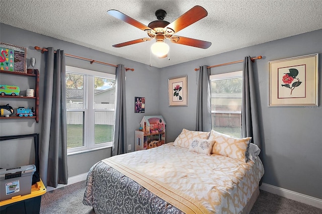 carpeted bedroom with a textured ceiling and ceiling fan