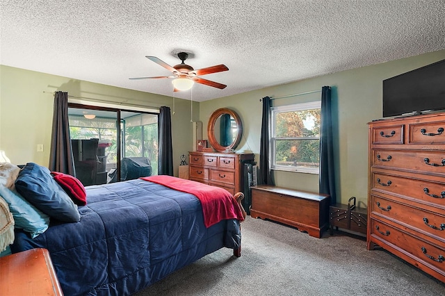 bedroom featuring access to exterior, a textured ceiling, carpet floors, and ceiling fan