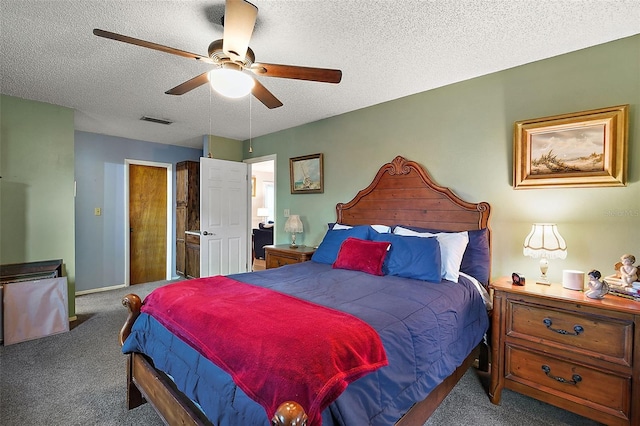 bedroom featuring carpet flooring, ceiling fan, and a textured ceiling