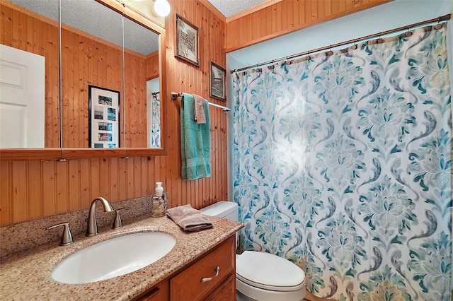 bathroom featuring vanity, a textured ceiling, toilet, and wood walls