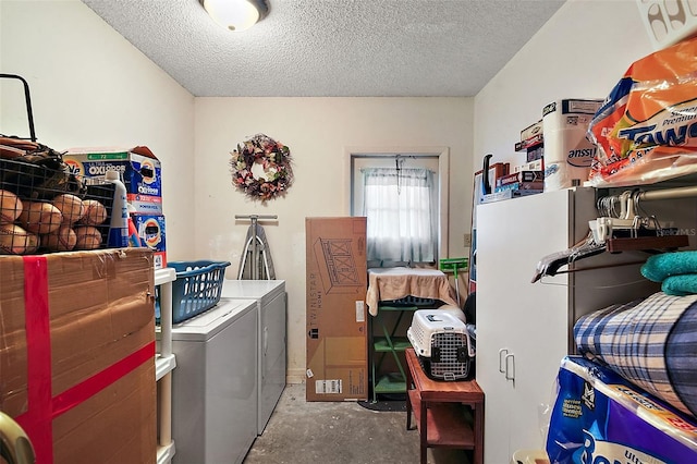 washroom featuring independent washer and dryer and a textured ceiling