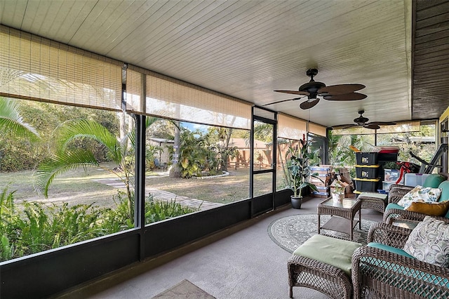 unfurnished sunroom featuring ceiling fan and a healthy amount of sunlight