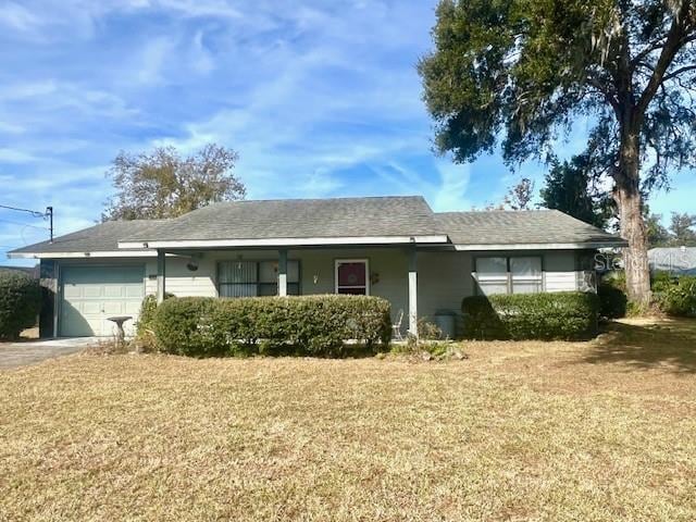 ranch-style home with a front lawn and a garage