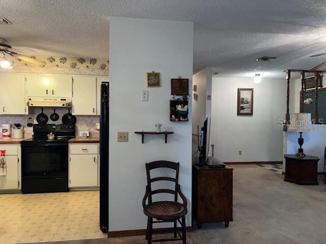 kitchen with black appliances, ceiling fan, a textured ceiling, and tasteful backsplash