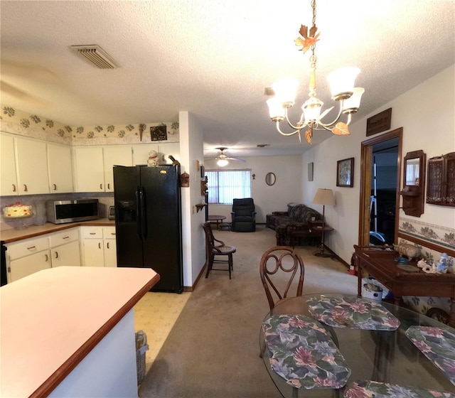 kitchen featuring light carpet, black fridge with ice dispenser, a textured ceiling, decorative light fixtures, and white cabinetry