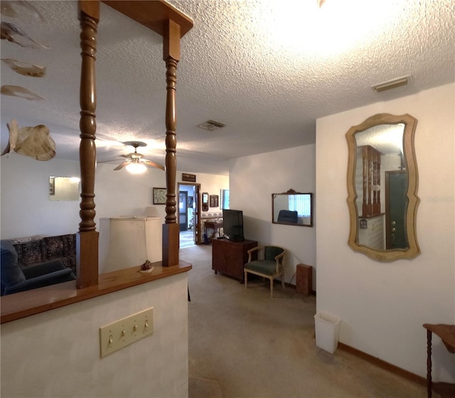 living room with carpet flooring, a textured ceiling, and ceiling fan