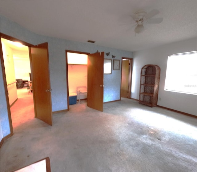 interior space featuring carpet flooring and ceiling fan