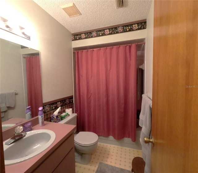 full bathroom with vanity, a textured ceiling, toilet, and shower / bathtub combination with curtain