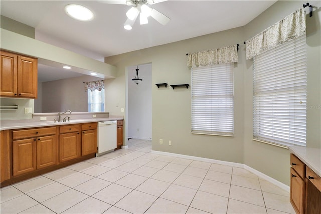 kitchen featuring ceiling fan, dishwasher, light tile patterned floors, and sink