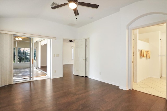 empty room featuring dark wood-type flooring and vaulted ceiling