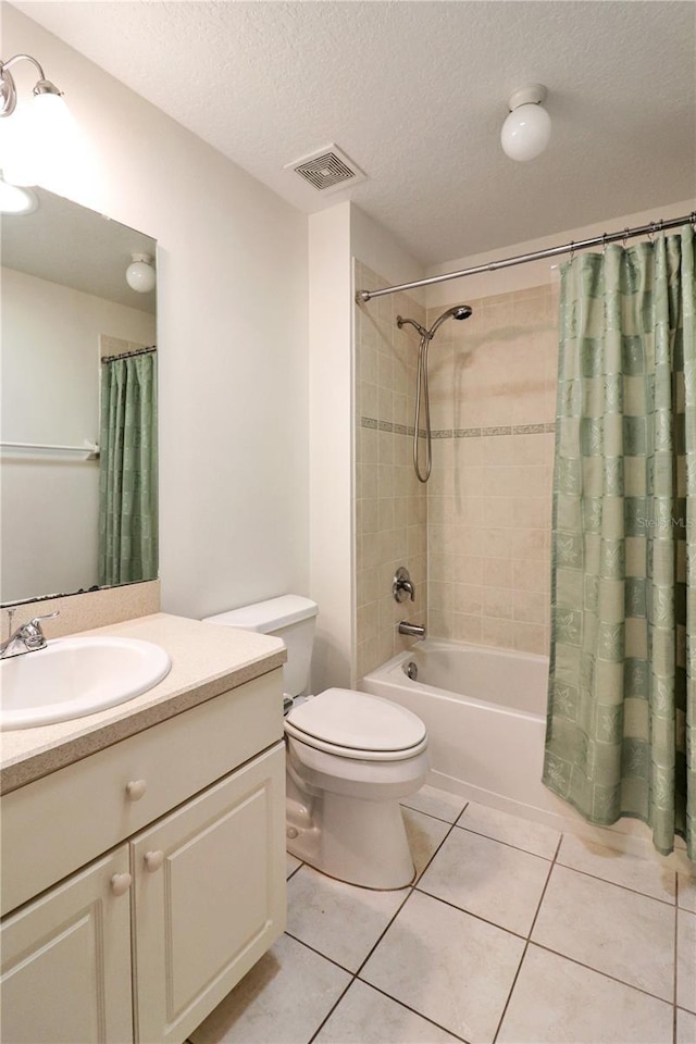 full bathroom featuring shower / tub combo, tile patterned floors, a textured ceiling, vanity, and toilet