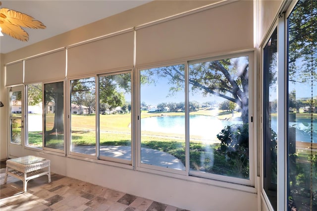 unfurnished sunroom with a water view and plenty of natural light