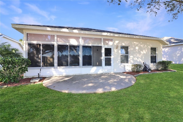 rear view of property with a lawn and a patio area