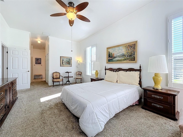 bedroom with ceiling fan and light carpet