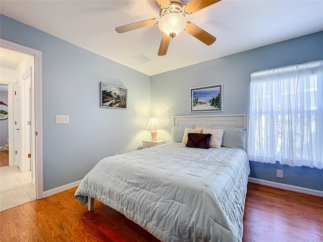 bedroom with ceiling fan and hardwood / wood-style floors