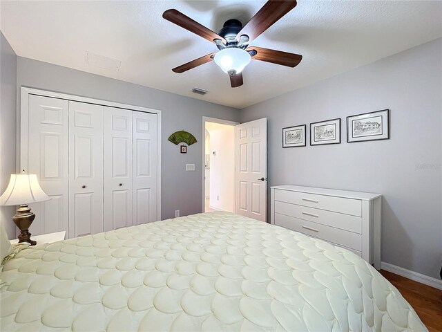 bedroom featuring ceiling fan, a closet, and hardwood / wood-style flooring