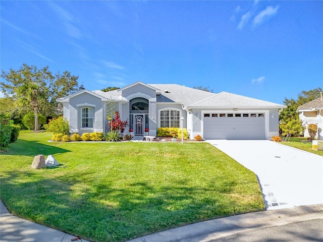 ranch-style home featuring a garage, driveway, a front lawn, and stucco siding