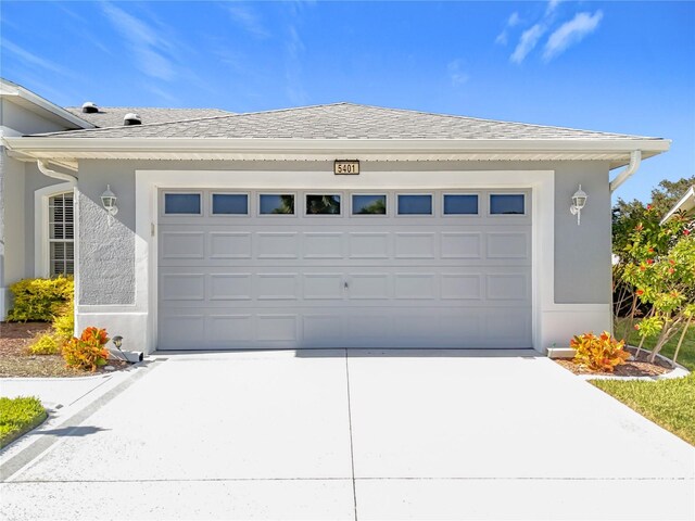 garage featuring concrete driveway