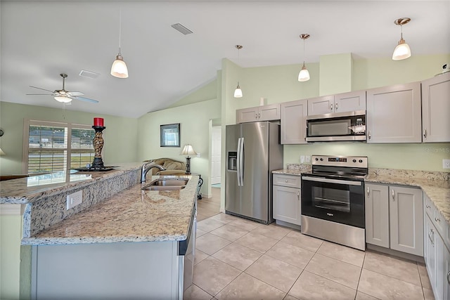 kitchen featuring pendant lighting, stainless steel appliances, vaulted ceiling, and sink