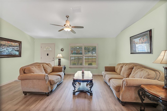 living room with light wood-type flooring and ceiling fan