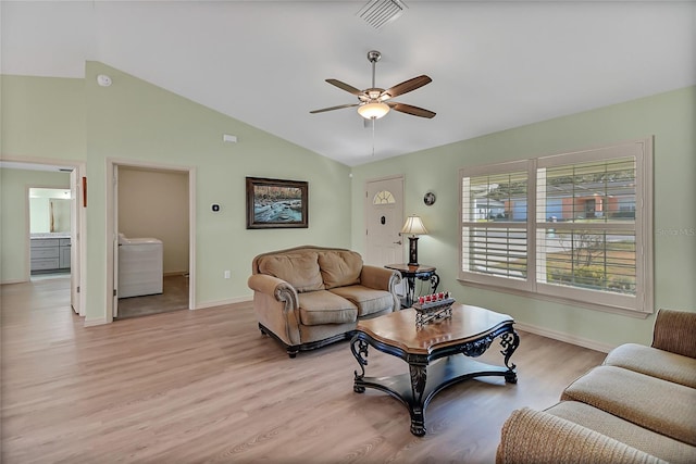 living room featuring ceiling fan, vaulted ceiling, and light wood-type flooring