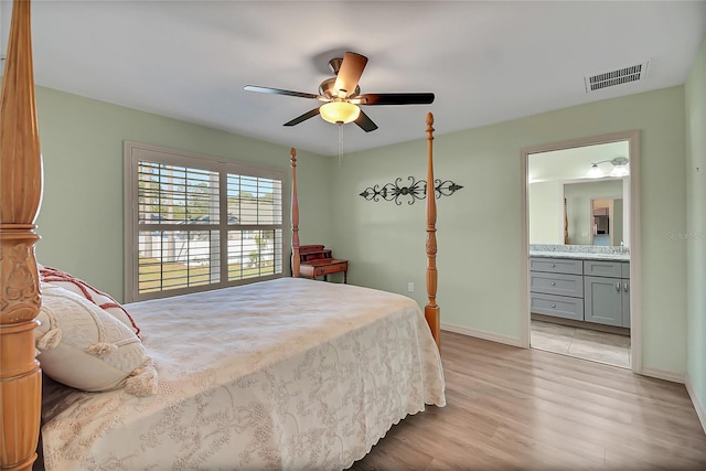 bedroom featuring connected bathroom, light hardwood / wood-style flooring, and ceiling fan