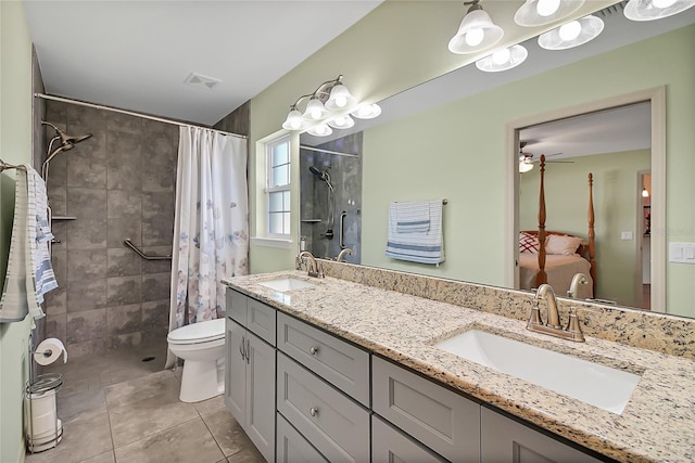 bathroom featuring walk in shower, vanity, ceiling fan, tile patterned flooring, and toilet